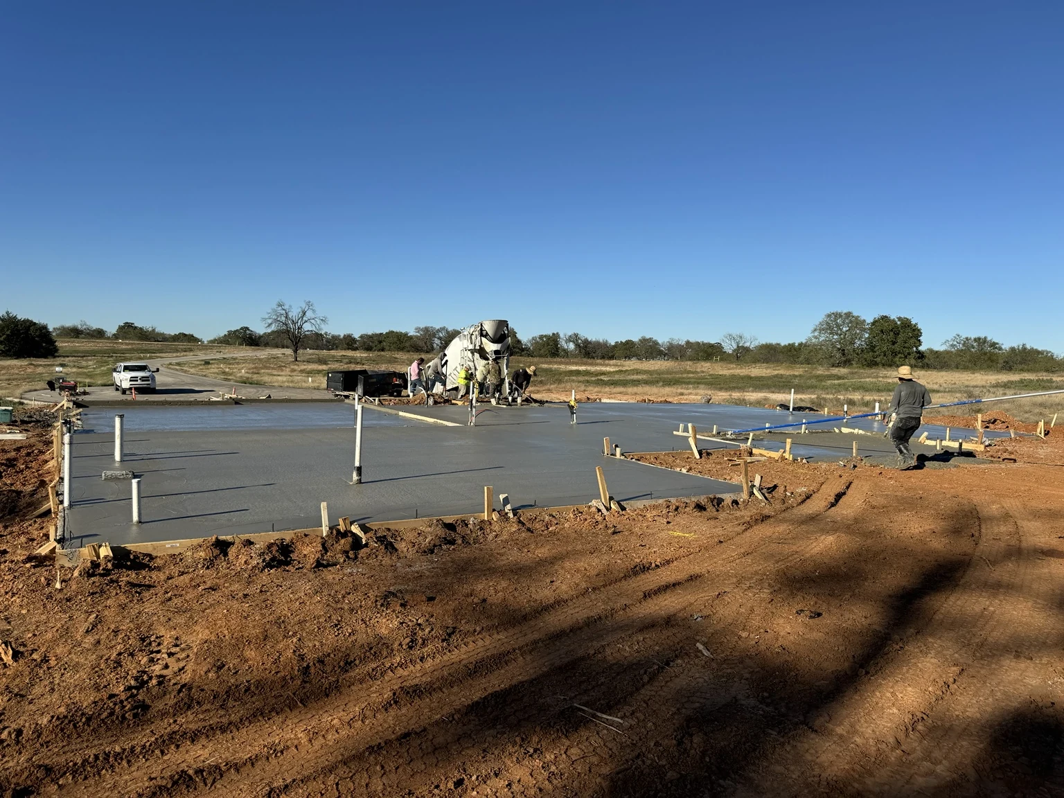 Concrete foundation placement with crew at work