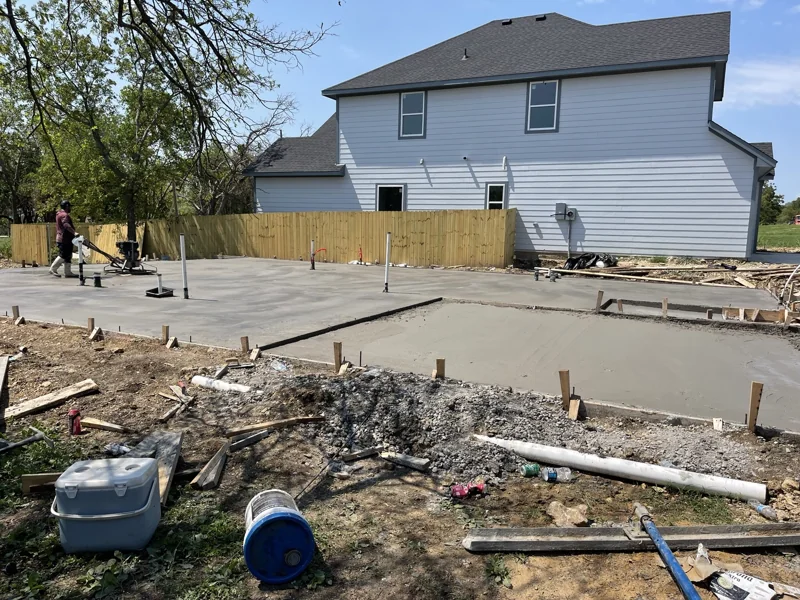 Residential concrete placement alongside an existing home